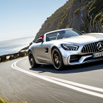 **Image Prompt:** Mercedes-Benz AMG GT Roadster speeding down a winding coastal road under a sunny sky. Top down, showcasing the luxurious interior and sporty exterior. Focus on the feeling of freedom and exhilaration.